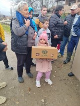 Meisje in Noord-Macedonië met haar ontvangen kerstdoos. 